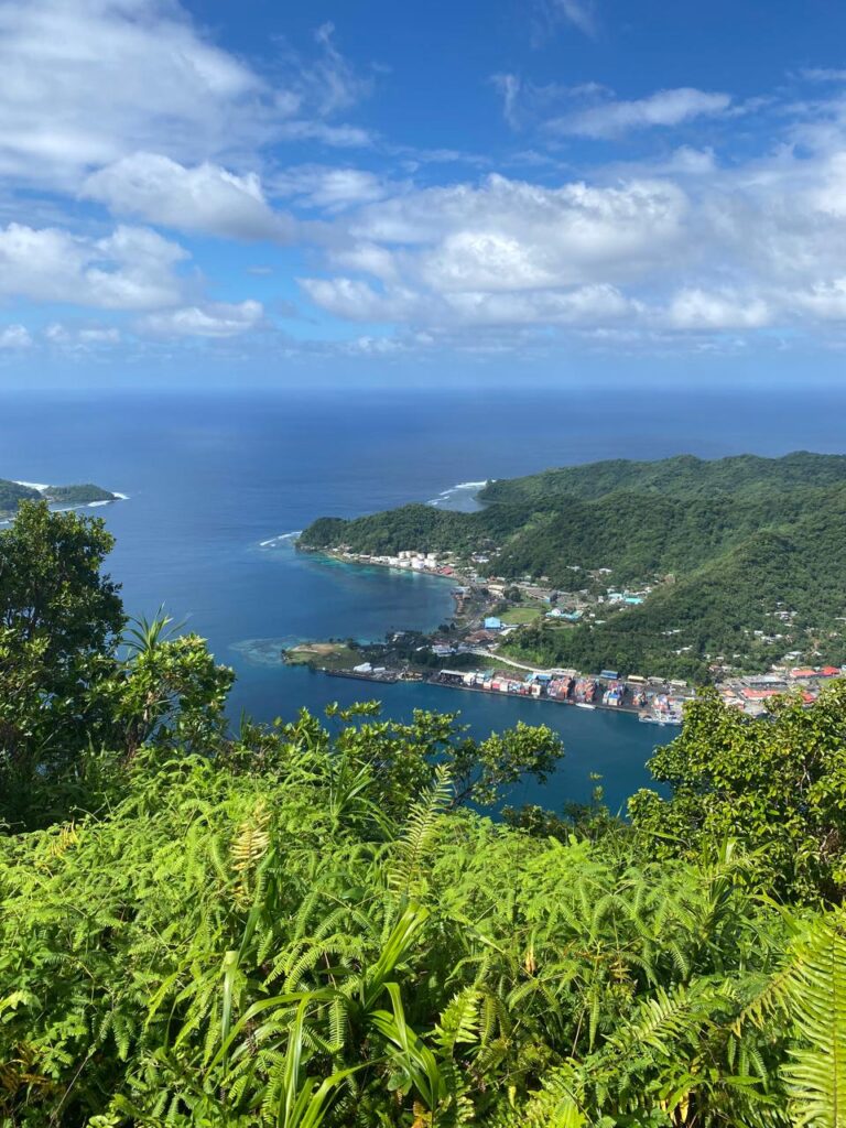 A beautiful image of Pago Pago harbor from high atop Mt Alva.  You see the harbor with puffy clouds and the amazing blue water of the Pacific Ocean