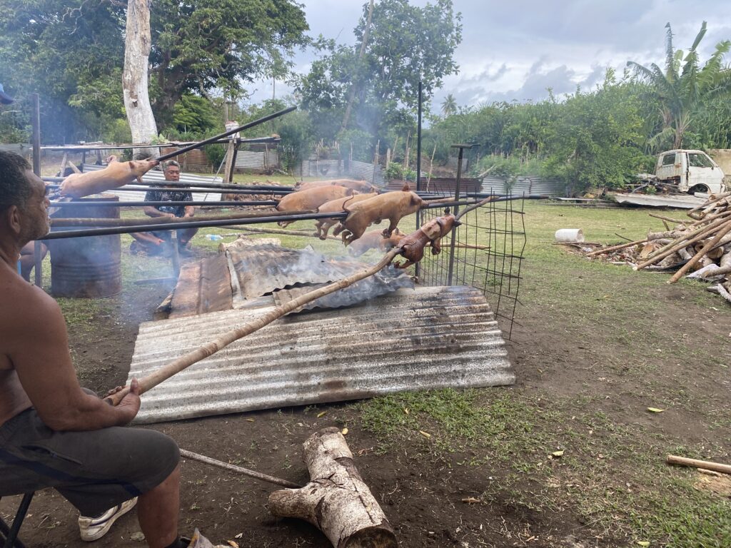 Men roasting pigs on Nuiatoputapu